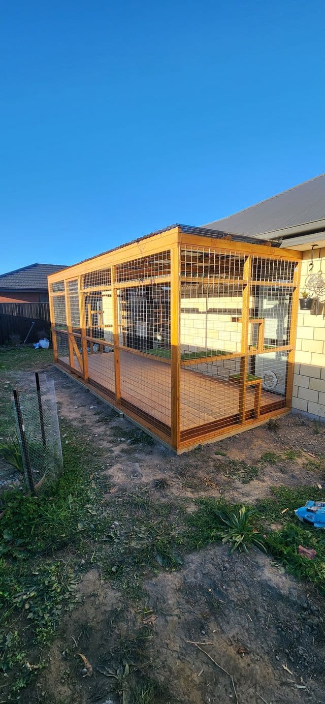 Long timber catio alongside a block wall in evening light